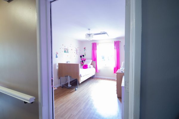 Modern bedroom with pink accent wall and contemporary design
