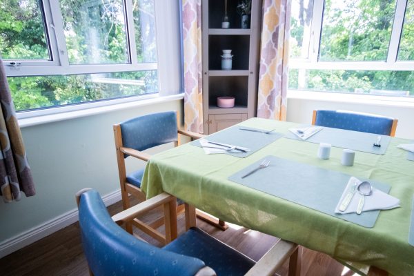 3 seats around dining table beside bright large windows