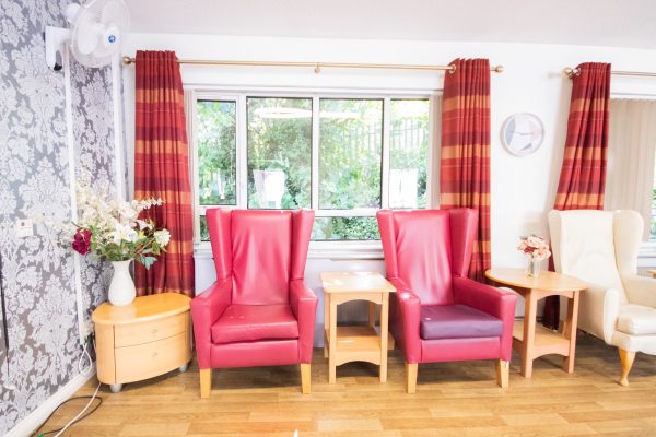 2 arm chairs beside big window