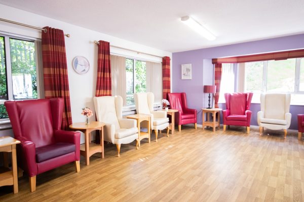 living area with pink and cream arm chairs